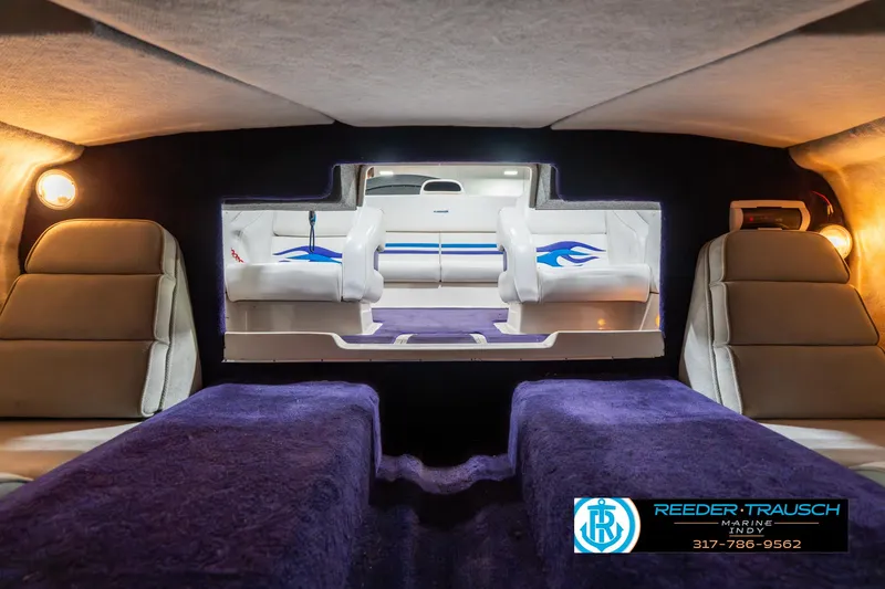 Slide: The Image of Interior of 2001 Eliminator 26 Daytona boat with plush seating and ambient lighting. - 18