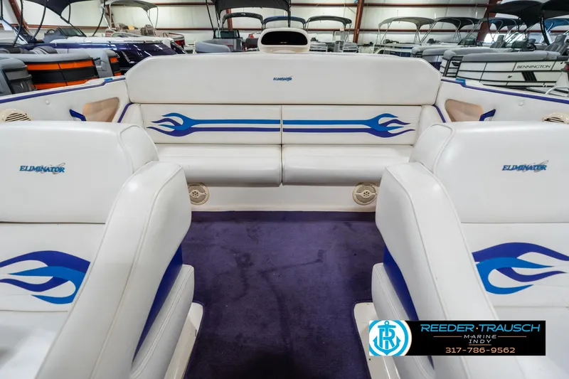 Slide: The Image of 2001 Eliminator 26 Daytona boat interior with white and blue flame design seating. - 19