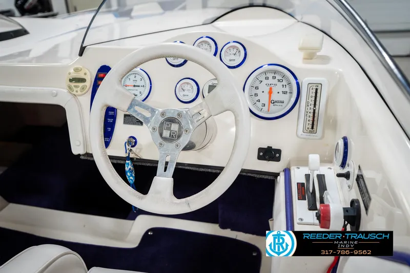 Slide: The Image of 2001 Eliminator 26 Daytona boat dashboard with steering wheel and gauges. - 22