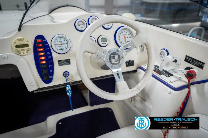Slide: The Image of 2001 Eliminator 26 Daytona boat dashboard with gauges and steering wheel. - 23