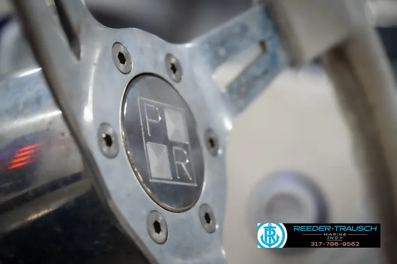 Slide: The Image of Steering wheel of a 2001 Eliminator 26 Daytona boat, featuring a metallic finish. - 24