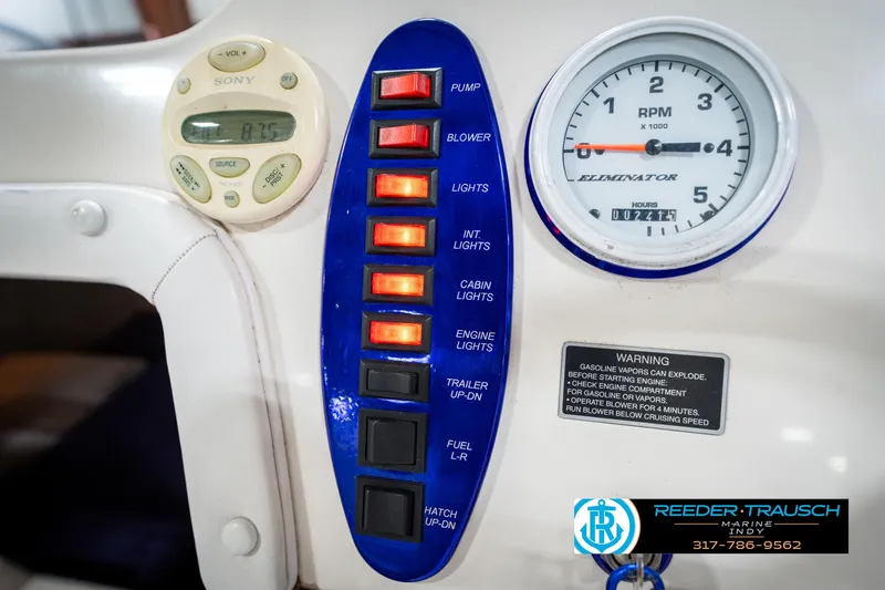 Slide: The Image of Control panel of a 2001 Eliminator 26 Daytona boat with switches and RPM gauge. - 25