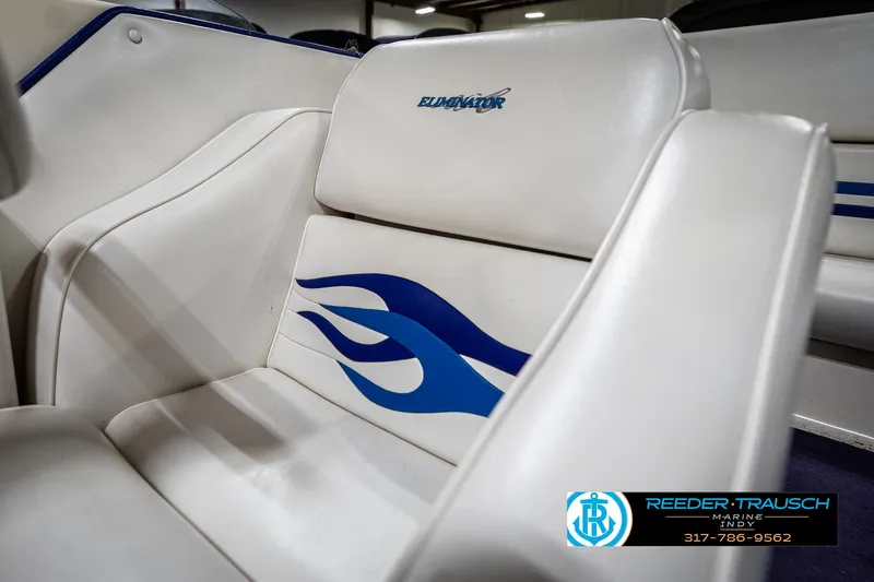 Slide: The Image of 2001 Eliminator 26 Daytona boat interior with white seats and blue flame design. - 29