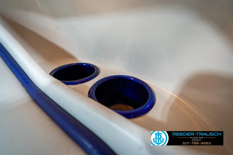 Slide: The Image of Cup holders in a 2001 Eliminator 26 Daytona boat interior with blue accents. - 31