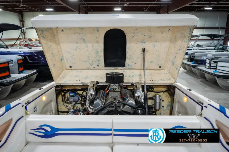 Slide: The Image of 2001 Eliminator 26 Daytona boat engine compartment with open hatch in a showroom. - 34