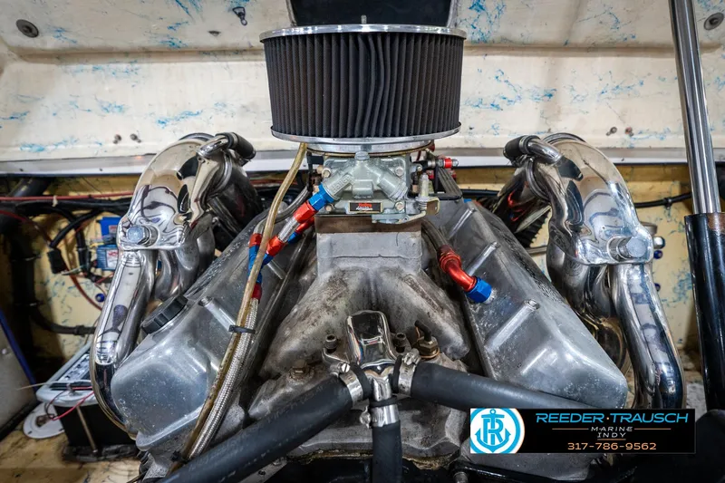 Slide: The Image of 2001 Eliminator 26 Daytona engine with chrome headers and air filter, Reeder-Trausch Marine logo. - 35
