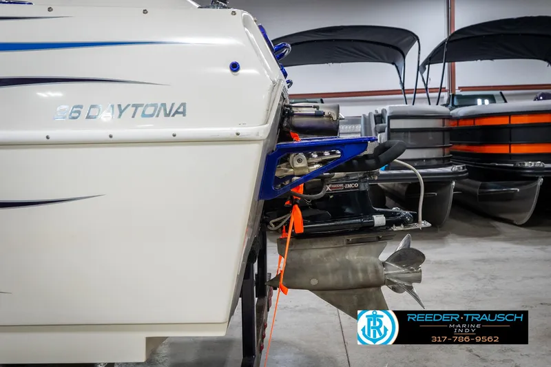 Slide: The Image of 2001 Eliminator 26 Daytona boat in showroom, featuring sleek design and powerful engine. - 38