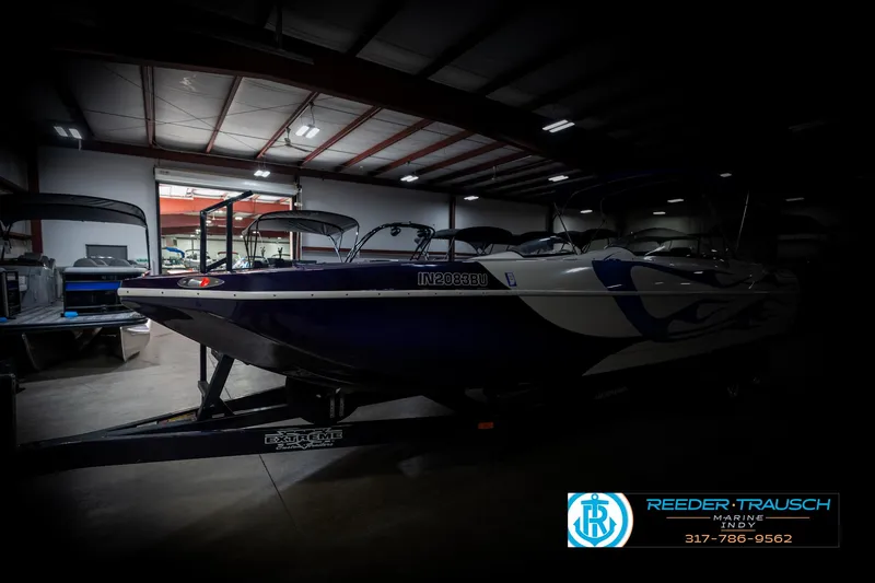 Slide: The Image of 2001 Eliminator 26 Daytona boat in a dimly lit indoor storage facility. - 4