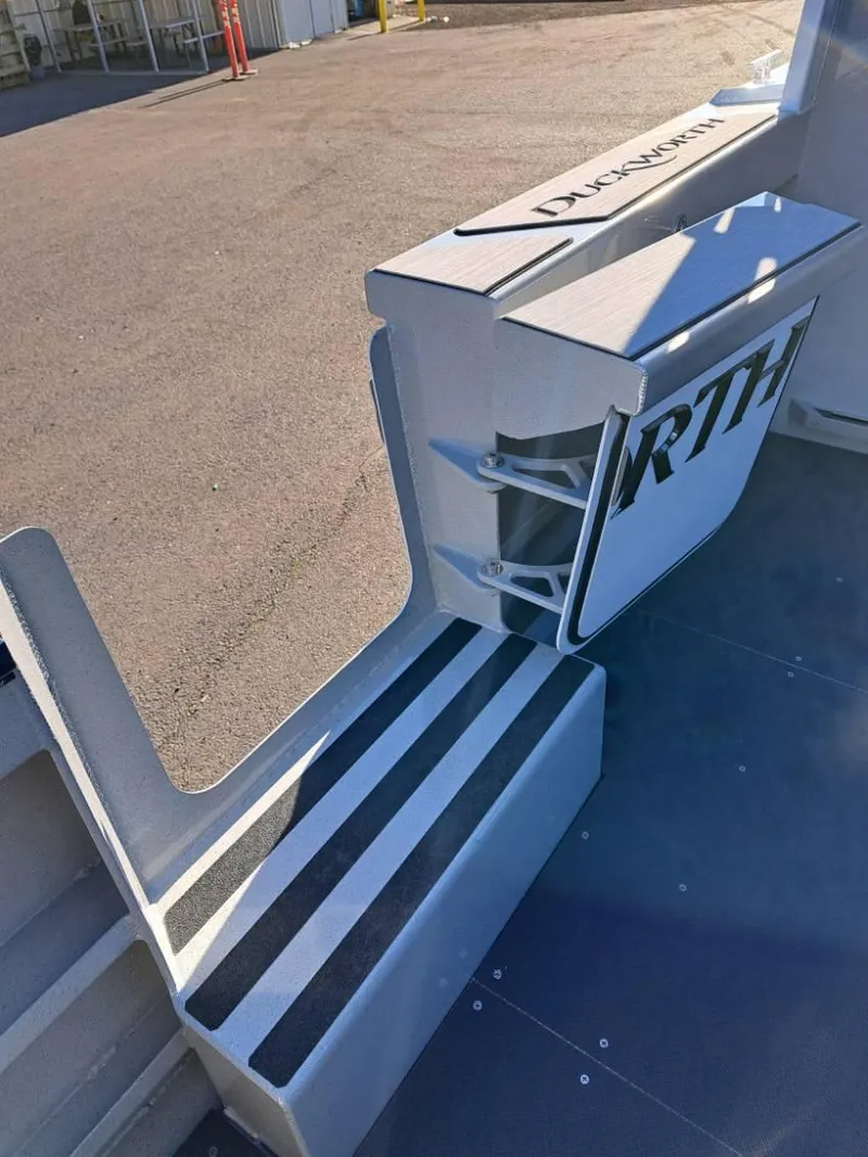Slide: The Image of Duckworth 28 Offshore 2025 boat interior with seating and storage compartments. - 6