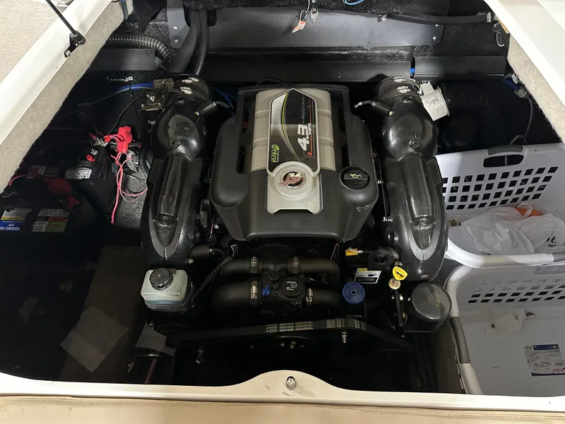 Slide: The Image of 2015 Stingray 215 LR boat engine compartment with visible components and wiring. - 13