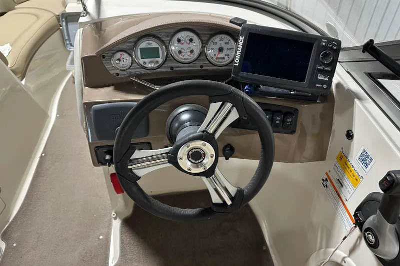 Slide: The Image of Steering console of a 2015 Stingray 215 LR boat with gauges and navigation system. - 18