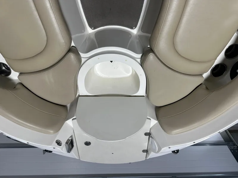 Slide: The Image of 2015 Stingray 215 LR boat interior with beige seating and white flooring. - 7