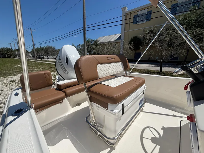 Slide: The Image of 2025 Pioneer 180 Islander boat interior with brown seating and outboard motor. - 11