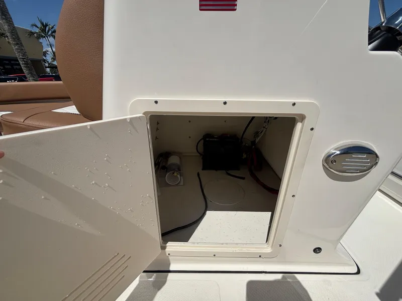 Slide: The Image of Storage compartment on a 2025 Pioneer 180 Islander boat, open to reveal interior. - 13