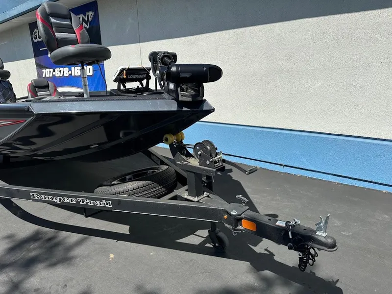 Slide: The Image of 2023 Ranger RT178 boat on trailer, parked outdoors, featuring sleek design and modern equipment. - 10