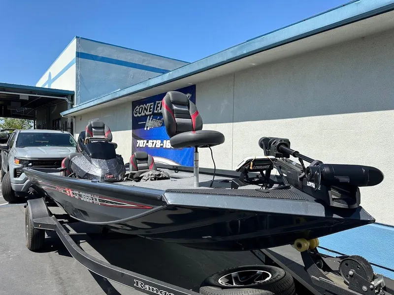 Slide: The Image of 2023 Ranger RT178 boat on trailer, parked outside a building. - 11
