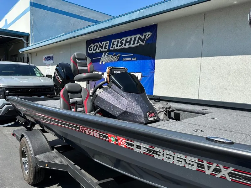 Slide: The Image of 2023 Ranger RT178 boat on trailer, parked outside a fishing store. - 12