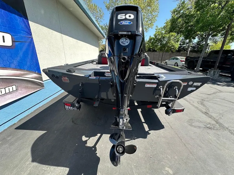 Slide: The Image of 2023 Ranger RT178 boat with a 60 HP outboard motor, parked outdoors. - 15