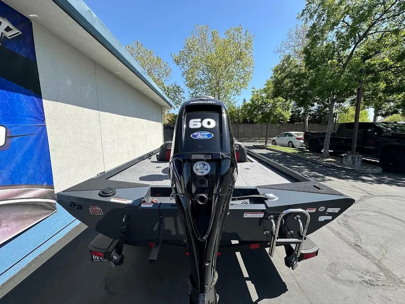 Slide: The Image of 2023 Ranger RT178 boat with a 60 HP motor, parked outdoors. - 16