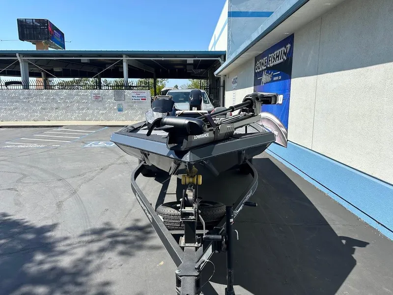 Slide: The Image of 2023 Ranger RT178 boat on trailer in parking lot, near blue and white building. - 3