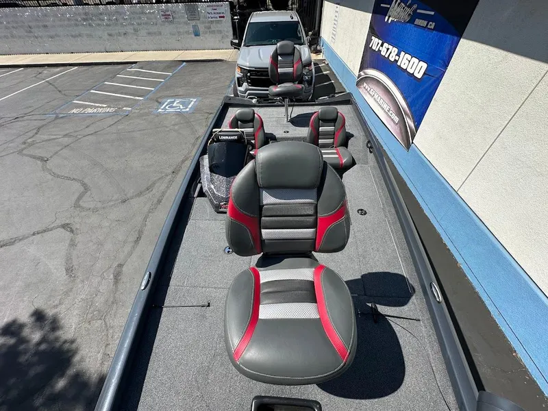 Slide: The Image of 2023 Ranger RT178 boat interior with gray and red seats in a parking lot. - 31
