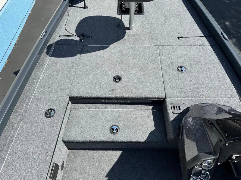 Slide: The Image of 2023 Ranger RT178 boat interior with gray carpet and storage compartments. - 33