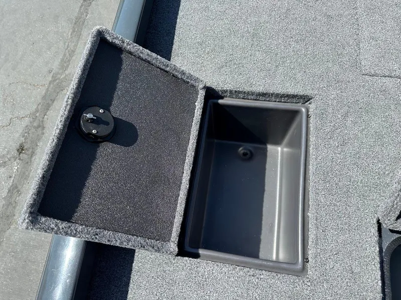Slide: The Image of 2023 Ranger RT178 boat storage compartment with open lid, showing interior space. - 39