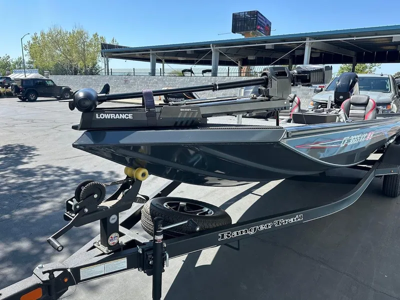 Slide: The Image of 2023 Ranger RT178 boat on trailer with Lowrance equipment, parked outdoors. - 4