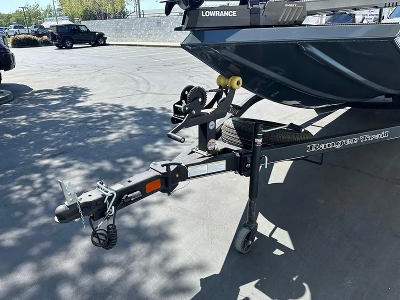 Slide: The Image of 2023 Ranger RT178 boat trailer with hitch and winch in a parking lot. - 5
