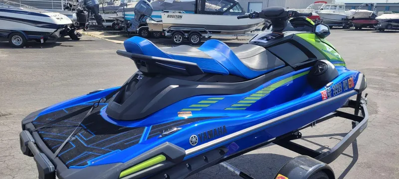 Slide: The Image of 2024 Yamaha Boats VX Limited HO jet ski in vibrant blue and green on a trailer. - 4