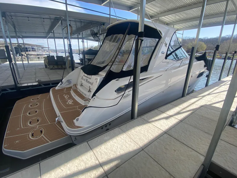 Slide: The Image of 2009 Sea Ray 350 Sundancer docked under a covered marina. - 0
