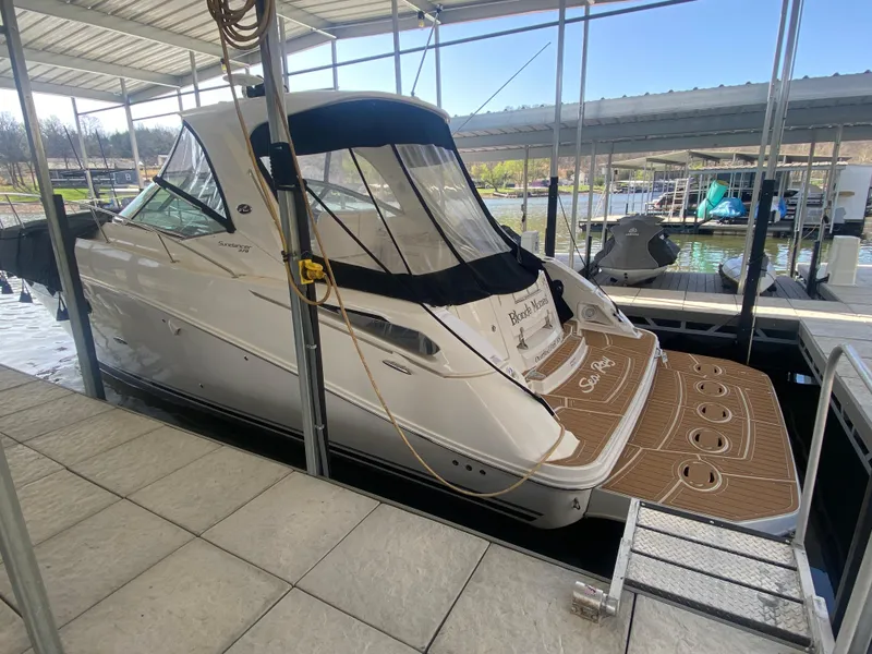 Slide: The Image of 2009 Sea Ray 350 Sundancer docked in a covered marina slip. - 1