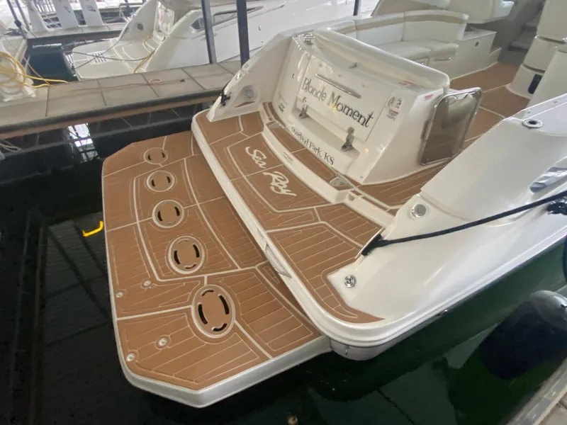 Slide: The Image of 2009 Sea Ray 350 Sundancer boat docked, featuring a spacious swim platform. - 10