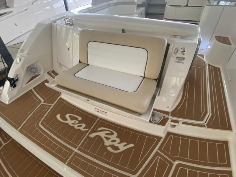 Slide: The Image of 2009 Sea Ray 350 Sundancer boat deck with cushioned seating and logo. - 11