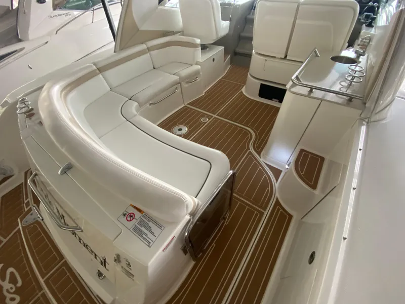 Slide: The Image of 2009 Sea Ray 350 Sundancer interior with white seating and wood-patterned flooring. - 12