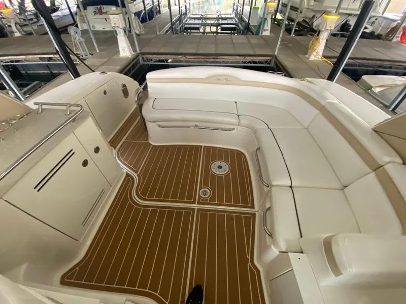 Slide: The Image of 2009 Sea Ray 350 Sundancer interior with white seating and wood-patterned flooring. - 13