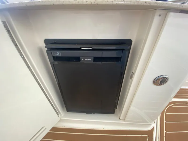 Slide: The Image of 2009 Sea Ray 350 Sundancer interior with Dometic fridge in white cabinetry. - 15