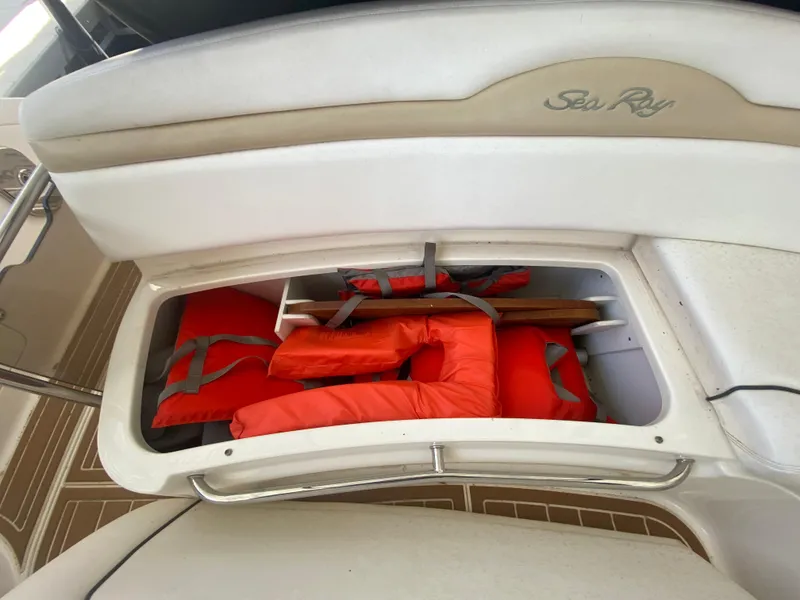 Slide: The Image of Storage compartment on 2009 Sea Ray 350 Sundancer with life jackets. - 16