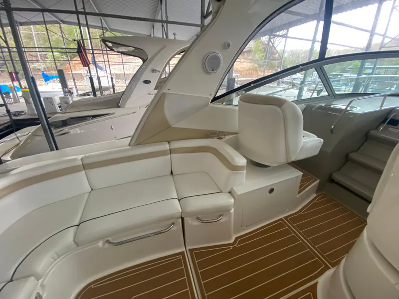 Slide: The Image of 2009 Sea Ray 350 Sundancer interior with white seating and wood flooring. - 17
