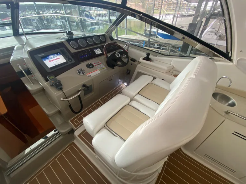 Slide: The Image of 2009 Sea Ray 350 Sundancer helm with modern controls and comfortable seating. - 19