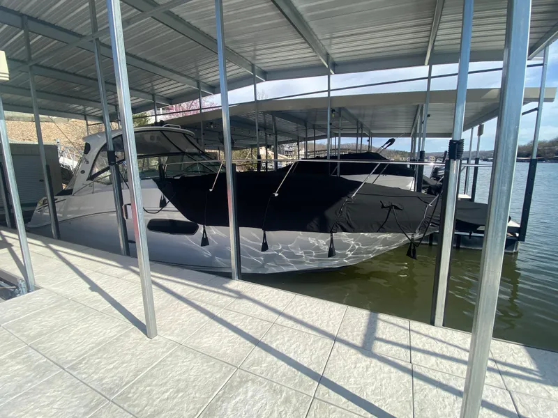 Slide: The Image of 2009 Sea Ray 350 Sundancer docked under covered marina. - 2