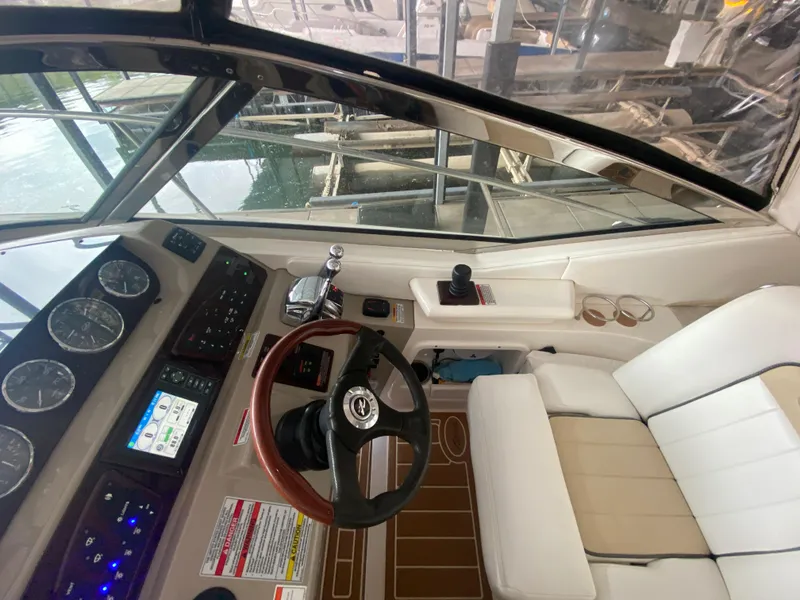 Slide: The Image of 2009 Sea Ray 350 Sundancer helm with gauges, steering wheel, and seating. - 20