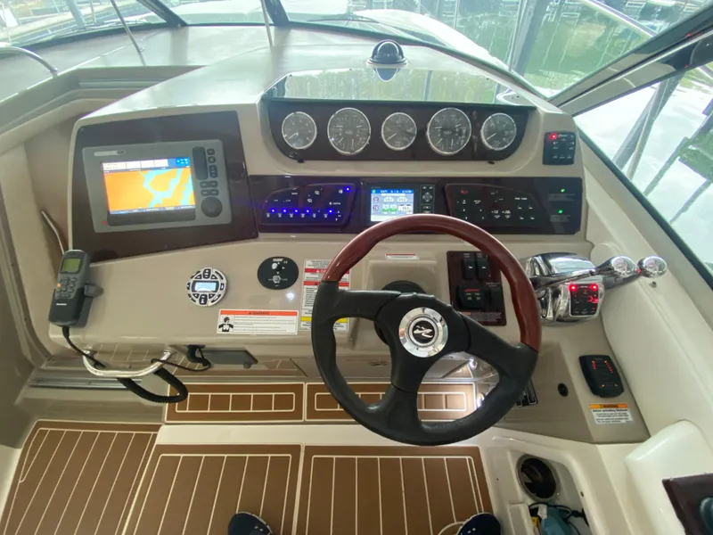 Slide: The Image of Helm of 2009 Sea Ray 350 Sundancer with navigation controls and steering wheel. - 21