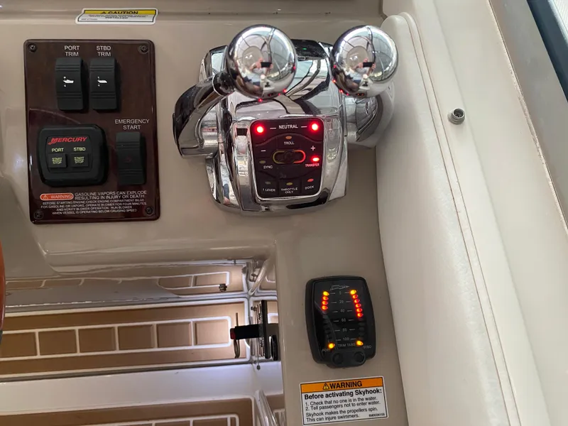 Slide: The Image of Control panel of a 2009 Sea Ray 350 Sundancer boat with throttle and switches. - 26