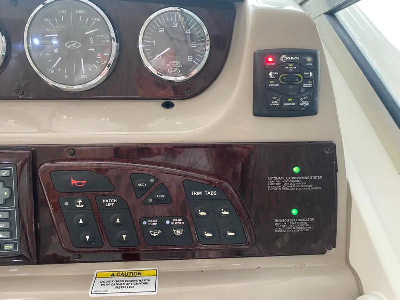 Slide: The Image of Control panel of a 2009 Sea Ray 350 Sundancer boat with gauges and switches. - 27