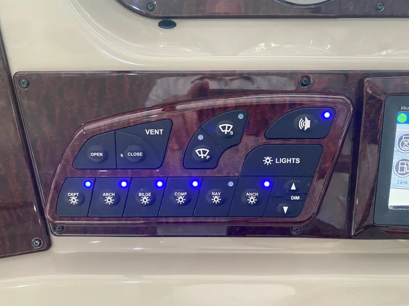 Slide: The Image of Control panel of a 2009 Sea Ray 350 Sundancer boat with illuminated buttons. - 28
