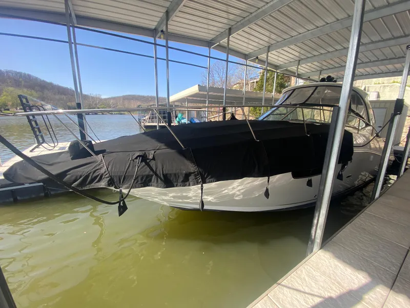 Slide: The Image of 2009 Sea Ray 350 Sundancer docked under a covered marina. - 3