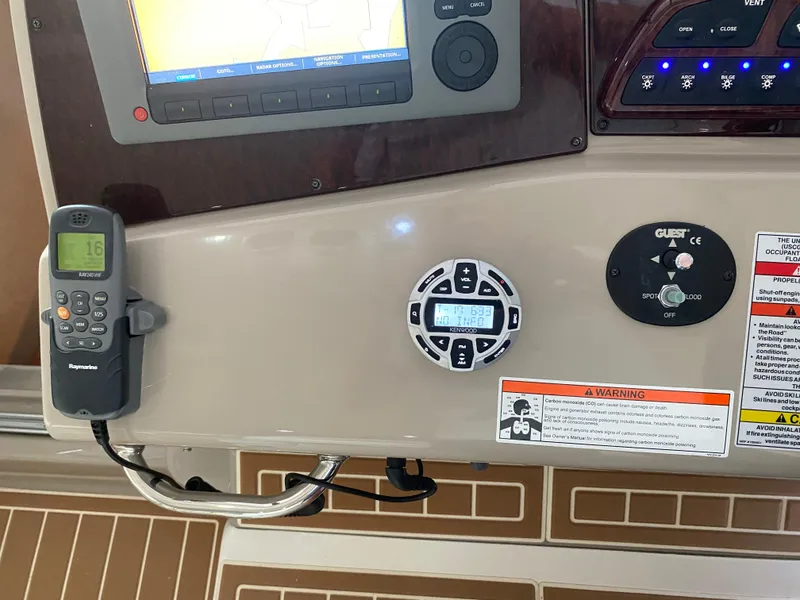 Slide: The Image of Control panel of a 2009 Sea Ray 350 Sundancer boat with navigation and communication devices. - 30