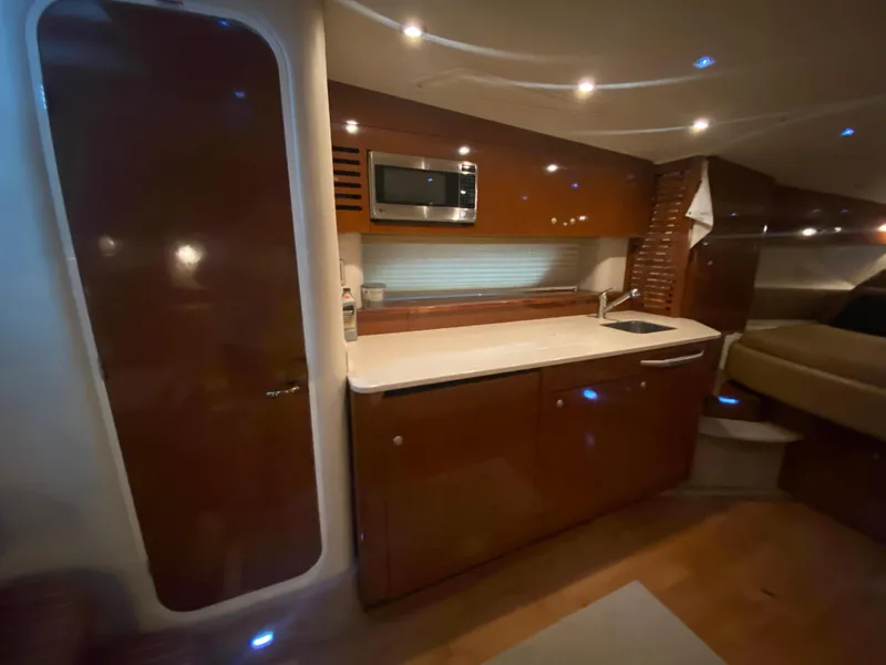Slide: The Image of Luxurious interior of 2009 Sea Ray 350 Sundancer yacht with modern kitchenette. - 32
