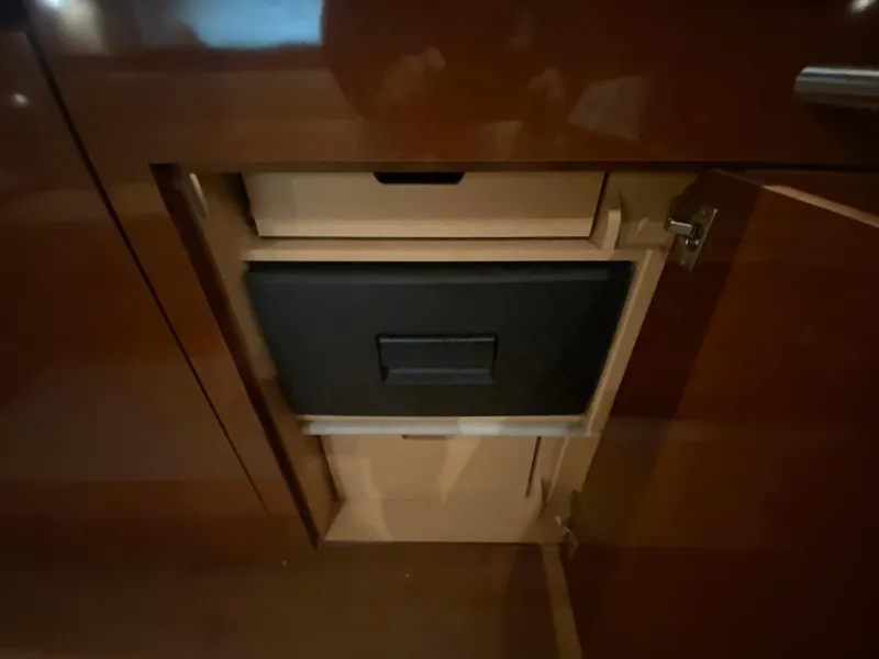 Slide: The Image of Cabinet interior of 2009 Sea Ray 350 Sundancer yacht, featuring a built-in drawer. - 36